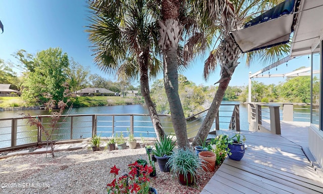 deck featuring a fenced backyard and a water view