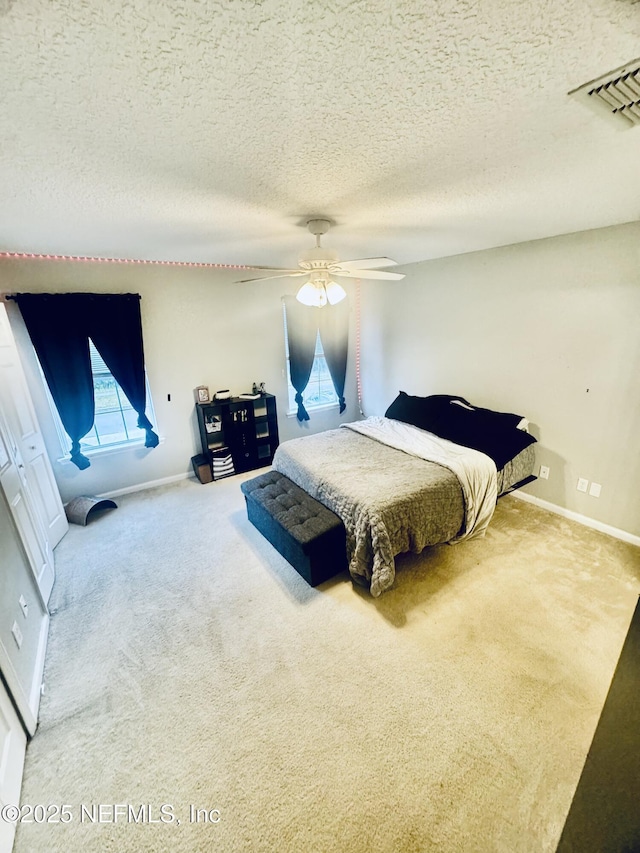 1845 Lago Del Sur Dr, Middleburg, FL 32068 - carpeted bedroom with a textured ceiling, baseboards, and a ceiling fan