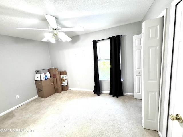 1845 Lago Del Sur Dr, Middleburg, FL 32068 - unfurnished bedroom featuring a textured ceiling, light colored carpet, baseboards, and a ceiling fan
