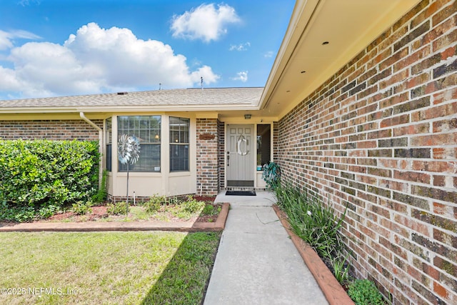 2629 Sandlewood Cir, Orange Park, FL 32065 - view of exterior entry featuring a shingled roof and brick siding