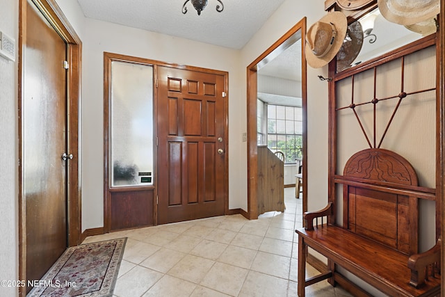 2629 Sandlewood Cir, Orange Park, FL 32065 - entrance foyer featuring light tile patterned flooring, a textured ceiling, and baseboards