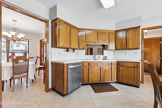 2629 Sandlewood Cir, Orange Park, FL 32065 - kitchen with a textured ceiling, brown cabinets, dishwasher, and light countertops