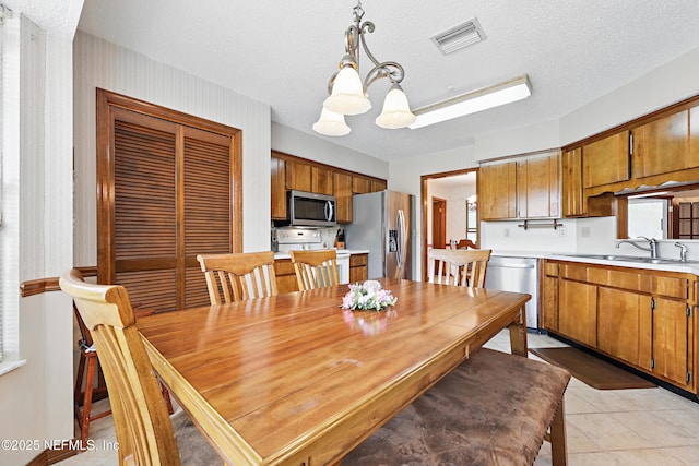 2629 Sandlewood Cir, Orange Park, FL 32065 - dining room with an inviting chandelier, a textured ceiling, visible vents, and light tile patterned floors