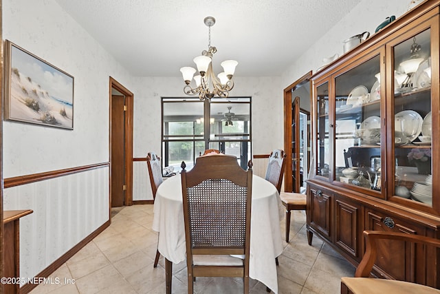 2629 Sandlewood Cir, Orange Park, FL 32065 - dining area featuring a textured ceiling, a chandelier, light tile patterned floors, and wallpapered walls