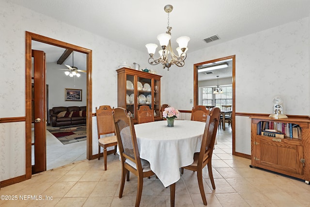 2629 Sandlewood Cir, Orange Park, FL 32065 - dining area featuring light tile patterned flooring, visible vents, wallpapered walls, and ceiling fan with notable chandelier