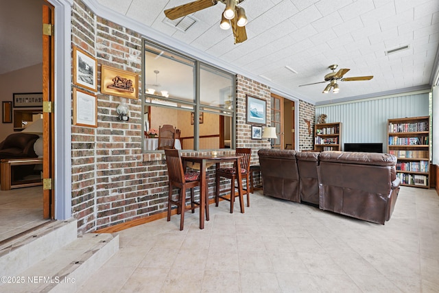 2629 Sandlewood Cir, Orange Park, FL 32065 - living area with ornamental molding, a ceiling fan, and brick wall