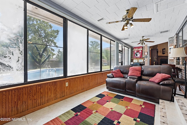 2629 Sandlewood Cir, Orange Park, FL 32065 - living area with tile patterned flooring, a ceiling fan, visible vents, and wood walls