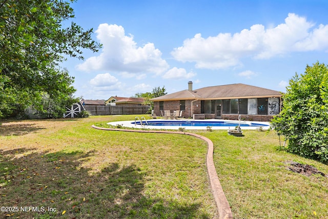 2629 Sandlewood Cir, Orange Park, FL 32065 - view of yard with a fenced in pool, a fenced backyard, and a sunroom