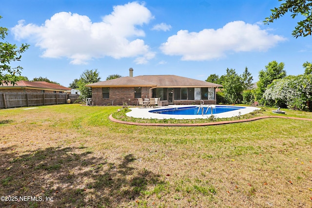 2629 Sandlewood Cir, Orange Park, FL 32065 - view of pool with a patio, a sunroom, a fenced in pool, a fenced backyard, and a lawn