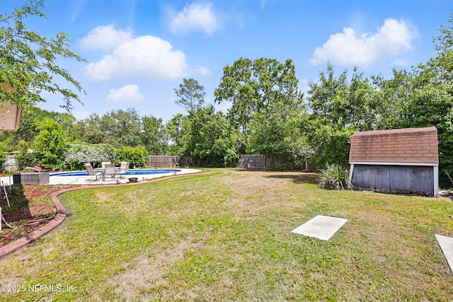 2629 Sandlewood Cir, Orange Park, FL 32065 - view of yard with an outbuilding, a storage shed, an outdoor pool, and a fenced backyard