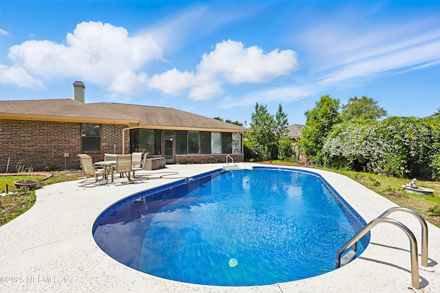 2629 Sandlewood Cir, Orange Park, FL 32065 - outdoor pool featuring a sunroom and a patio area