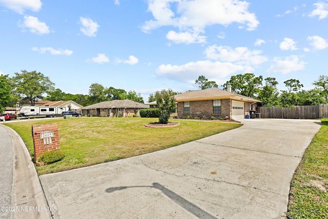 2629 Sandlewood Cir, Orange Park, FL 32065 - ranch-style house with concrete driveway, a chimney, a front yard, an attached garage, and fence