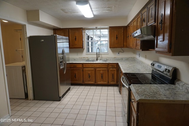 kitchen with a sink, stainless steel appliances, light countertops, under cabinet range hood, and light tile patterned flooring