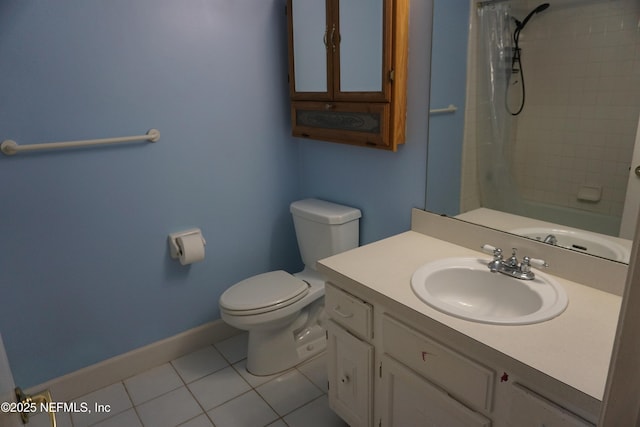 bathroom featuring toilet, tile patterned flooring, vanity, and baseboards