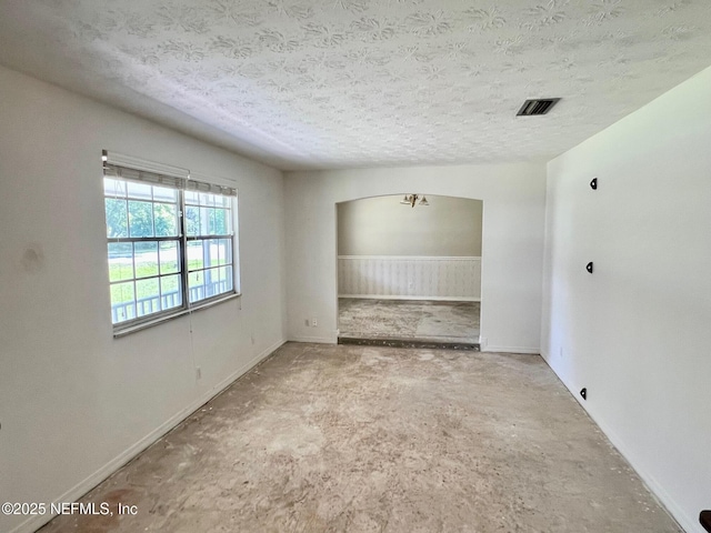 spare room featuring a textured ceiling and visible vents
