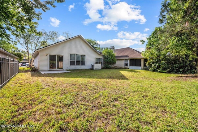 1884 Lake Forest Ln, Fleming Island, FL 32003 - rear view of property with a lawn, a patio, and fence