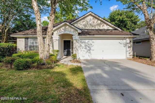 1884 Lake Forest Ln, Fleming Island, FL 32003 - view of front facade featuring concrete driveway, stucco siding, roof with shingles, a front yard, and a garage