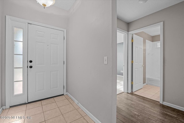 1884 Lake Forest Ln, Fleming Island, FL 32003 - foyer with light wood-type flooring, baseboards, and a healthy amount of sunlight