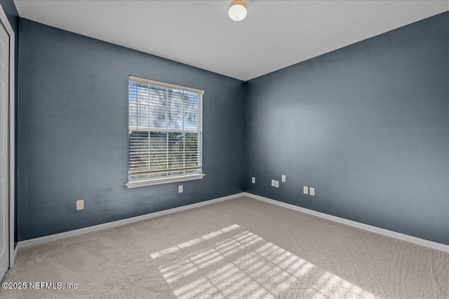 1884 Lake Forest Ln, Fleming Island, FL 32003 - spare room with baseboards, a textured ceiling, and carpet