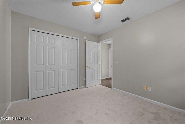 1884 Lake Forest Ln, Fleming Island, FL 32003 - unfurnished bedroom featuring carpet, visible vents, a closet, baseboards, and a textured ceiling