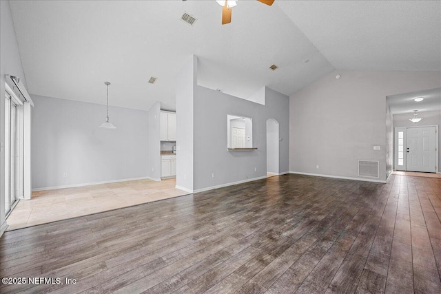 1884 Lake Forest Ln, Fleming Island, FL 32003 - unfurnished living room with high vaulted ceiling, a ceiling fan, hardwood / wood-style floors, and visible vents
