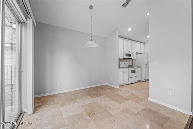 1884 Lake Forest Ln, Fleming Island, FL 32003 - kitchen featuring vaulted ceiling, baseboards, white cabinetry, white appliances, and pendant lighting
