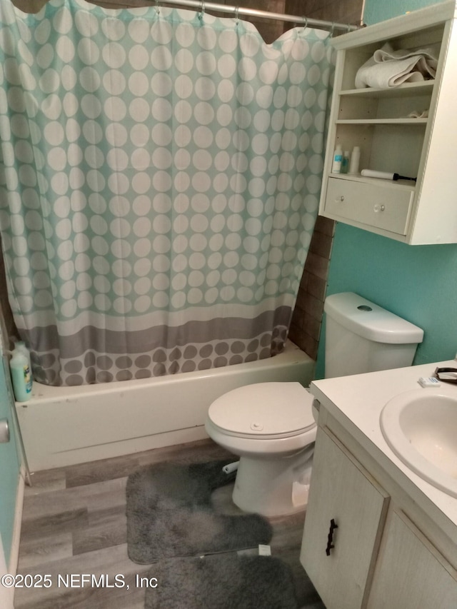 274 Hermosa Ct, Saint Augustine, FL 32086 - bathroom featuring wood finished floors, shower / bath combo with shower curtain, toilet, and vanity