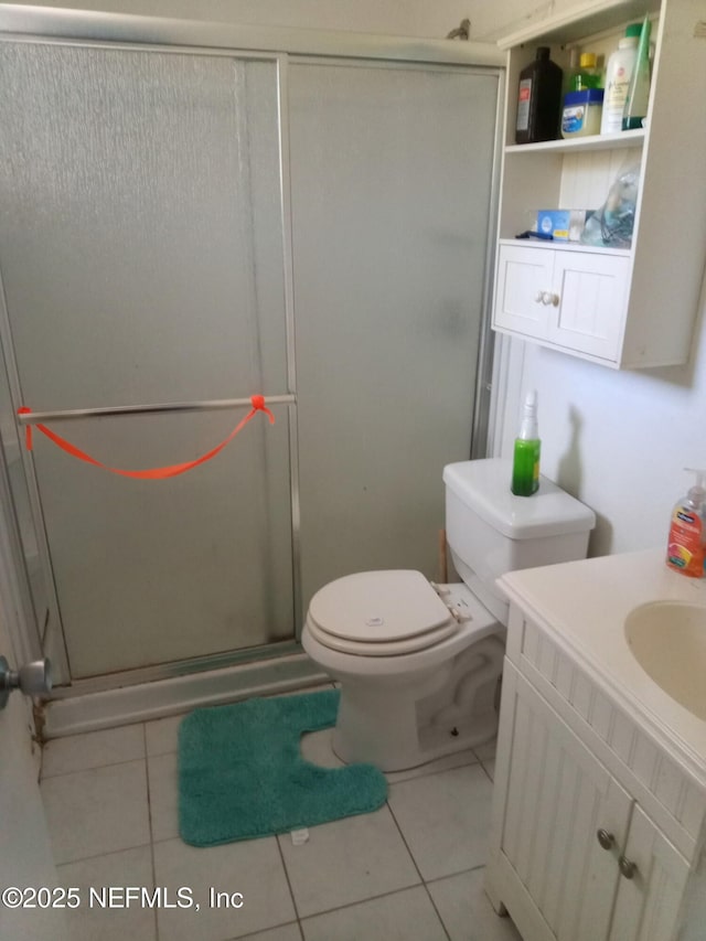 274 Hermosa Ct, Saint Augustine, FL 32086 - bathroom with vanity, tile patterned flooring, a shower stall, and toilet