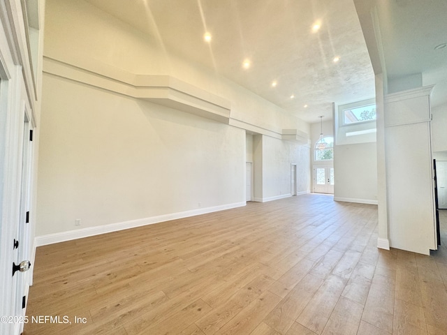 21 Bay Pointe Dr, Ormond Beach, FL 32174 - unfurnished living room featuring light wood-style floors, baseboards, and recessed lighting