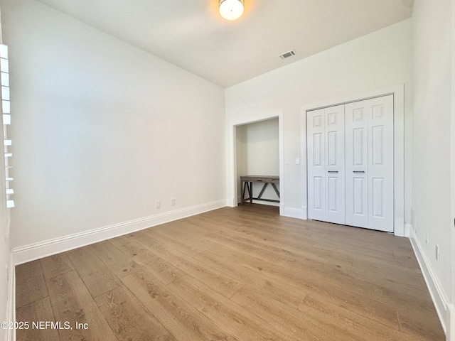 21 Bay Pointe Dr, Ormond Beach, FL 32174 - unfurnished bedroom featuring light wood-style flooring, a closet, and baseboards
