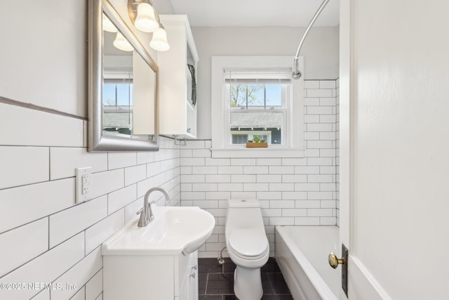 full bath with vanity, tile walls, toilet, shower / bathtub combination, and tile patterned flooring