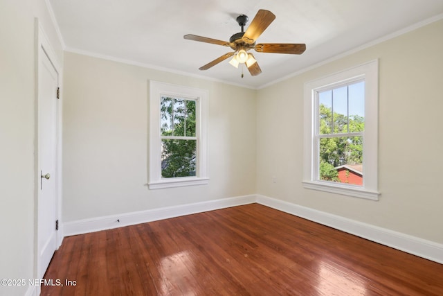 unfurnished room with hardwood / wood-style flooring, ceiling fan, baseboards, and crown molding