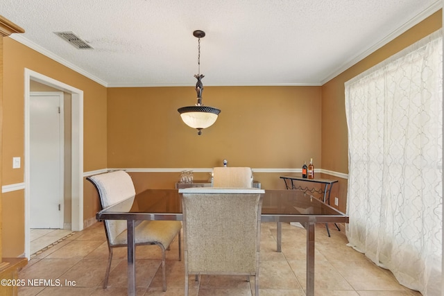 930 Ironridge Ct, Orange Park, FL 32065 - dining space featuring a textured ceiling, light tile patterned floors, baseboards, ornamental molding, and visible vents