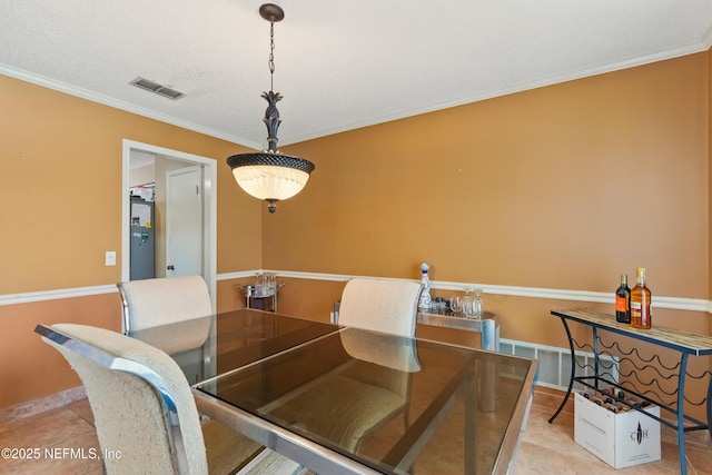 930 Ironridge Ct, Orange Park, FL 32065 - dining space featuring light tile patterned flooring, baseboards, visible vents, and crown molding