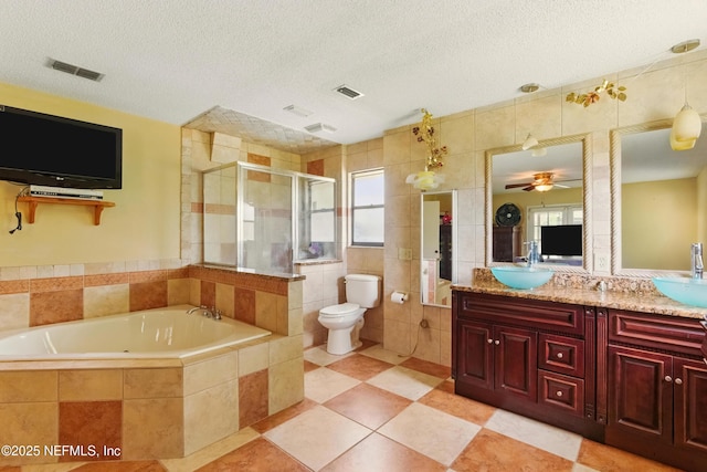 930 Ironridge Ct, Orange Park, FL 32065 - full bathroom with tile walls, a garden tub, visible vents, and a stall shower