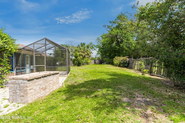 930 Ironridge Ct, Orange Park, FL 32065 - view of yard featuring a fenced backyard and glass enclosure