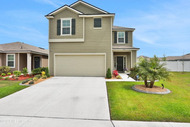 2235 Falling Star Ln, Green Cove Springs, FL 32043 - view of front facade with concrete driveway, a front lawn, fence, and a garage