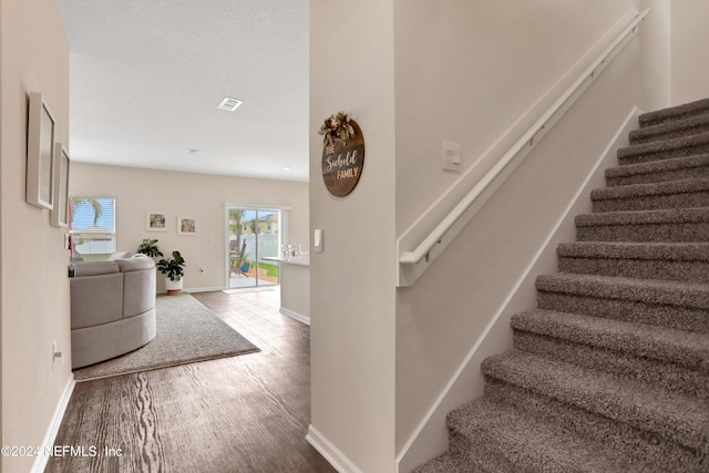 2235 Falling Star Ln, Green Cove Springs, FL 32043 - staircase featuring baseboards, wood finished floors, and visible vents