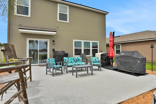 2235 Falling Star Ln, Green Cove Springs, FL 32043 - rear view of property featuring stucco siding, a patio, and an outdoor hangout area