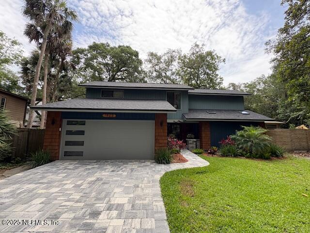 1825 Hickory Ln, Atlantic Beach, FL 32233 - mid-century inspired home with decorative driveway and an attached garage