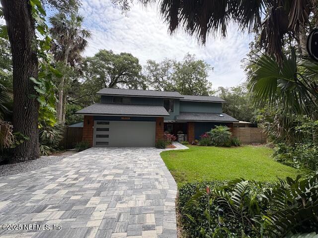1825 Hickory Ln, Atlantic Beach, FL 32233 - view of front of house featuring decorative driveway and an attached garage