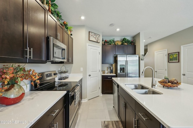 312 Anthony Dr, Jacksonville, FL 32218 - kitchen with dark brown cabinetry, a sink, light countertops, stainless steel appliances, and an island with sink