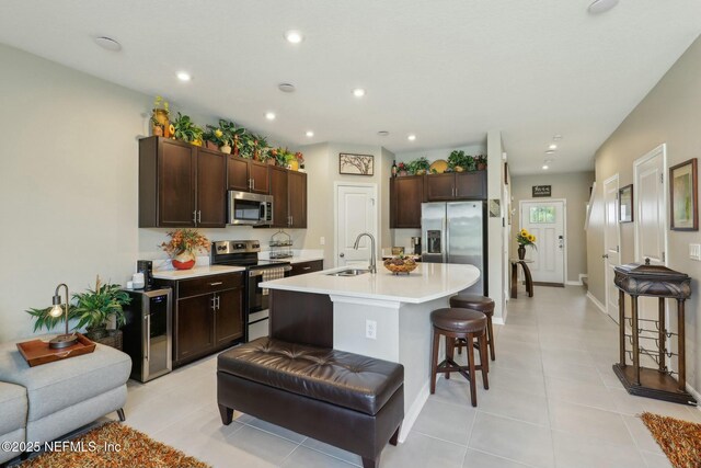 312 Anthony Dr, Jacksonville, FL 32218 - kitchen featuring a sink, light tile patterned floors, stainless steel appliances, and dark brown cabinets