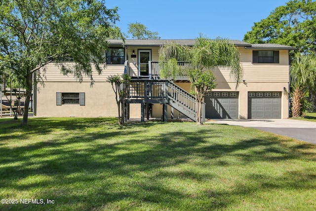 4068 Scenic Dr, Middleburg, FL 32068 - view of front of property with stairway, concrete driveway, an attached garage, a front yard, and stucco siding