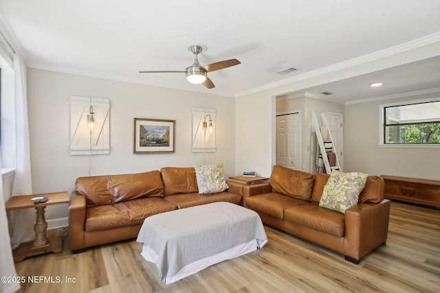4068 Scenic Dr, Middleburg, FL 32068 - living room featuring ornamental molding, light wood-style flooring, visible vents, and ceiling fan