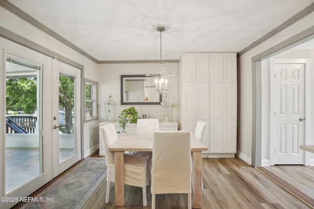 4068 Scenic Dr, Middleburg, FL 32068 - dining room with french doors, light wood-style flooring, baseboards, a chandelier, and crown molding