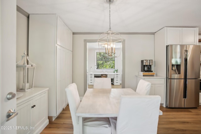 4068 Scenic Dr, Middleburg, FL 32068 - dining room with crown molding, a chandelier, and wood finished floors