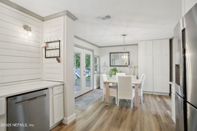 4068 Scenic Dr, Middleburg, FL 32068 - dining area with light wood finished floors, visible vents, a notable chandelier, and ornamental molding
