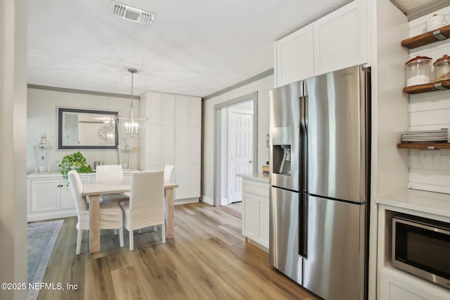 4068 Scenic Dr, Middleburg, FL 32068 - kitchen featuring light countertops, visible vents, white cabinetry, and stainless steel appliances
