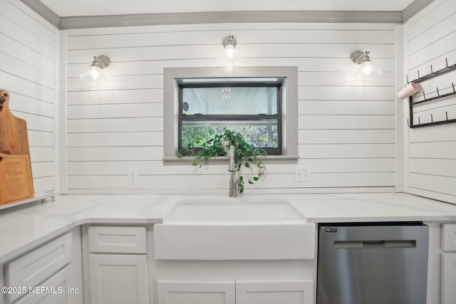 4068 Scenic Dr, Middleburg, FL 32068 - details with white cabinets, stainless steel dishwasher, wooden walls, and a sink